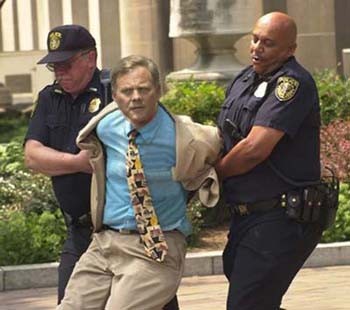 Sen. Richard Burr being arrested by the Hypocrisy Police