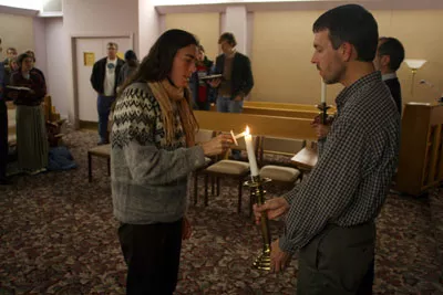 Sheila Stumph and Scott Bass lighting a candle at a prayer vigil for Willie Brown. - SCOTT LANGLEY