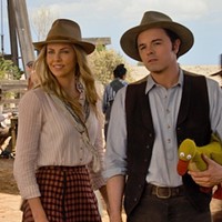 SHOOTING BLANKS: Seth MacFarlane (pictured with Charlize Theron) elected to (mis)cast himself in A Million Ways to Die in the West. (Photo: Universal)