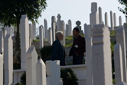 KAREN BALLARD / THE WEINSTEIN COMPANY - THE COST OF WAR: Simon (Richard Gere) and Duck (Terrence Howard) walk among the dead in The Hunting Party.