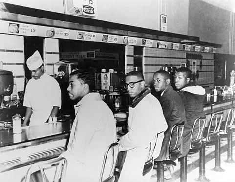 The Greensboro Four sit in at Woolworth's lunch counter. F. McCain is second from left