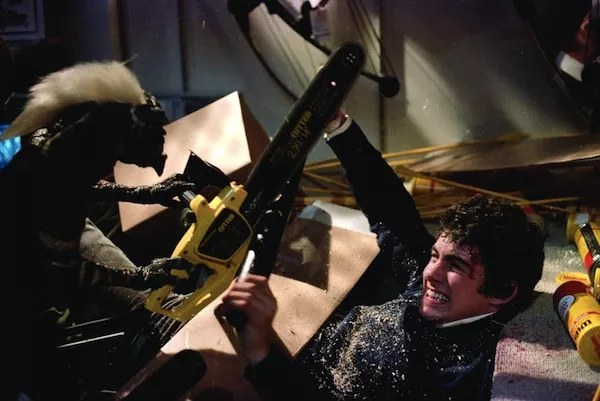 THE GREMLIN CHAIN SAW MASSACRE: Billy (Zach Galligan) protects himself in Gremlins. (Photo courtesy Warner Bros.)