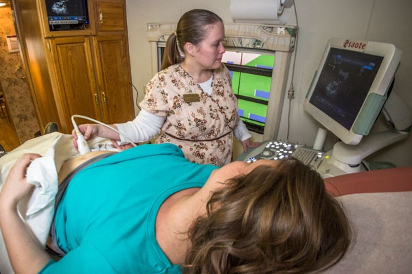 To protect the anonymity of women seeking counseling, Courtney Parks, R.N., demonstrates the ultrasound procedure she performs on women considering abortion using Christina Parker. The two attend the same church in Concord. - GRANT BALDWIN