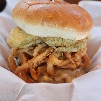 TRASHY AND YET ... : The White Trash Burger is topped with provolone, fried pickles, onion rings and spicy ranch sauce.