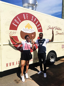 Saloan Rochelle (left) and Rel Dunlap pose with the truck.