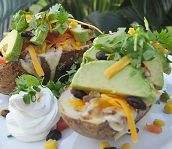 Southwest potato skin stuffed with homefried style potatoes with black beans, corn, cheese and avocado.