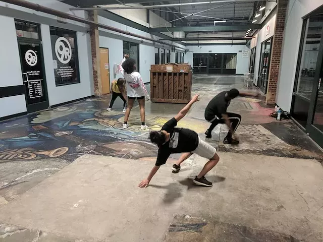 Crayzee Collective dancers rehearse in the atrium of NoDa @ 28th. (Photo by Ryan Pitkin)