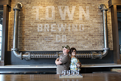 Brian Quinn (left) and Heather Wendrow behind the new bar in the taproom. (Photo by Courtney Mihocik)