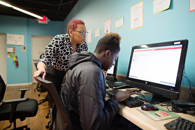 Resource coordinator Genine Donovan helps a client in the On Ramp upstairs resource center. (Photo by The Beautiful Mess)
