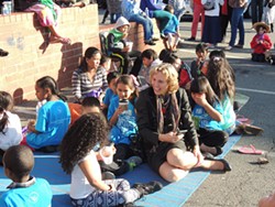 Newly elected Mayor Jennifer Roberts hangs with children outside of the ourBRIDGE offices during a Welcome Refugees event. (Photo by Ryan Pitkin)