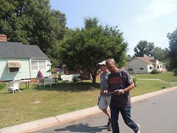 Tefere Gebre, executive director with the national AFL-CIO canvasses in the Charlotte’s Wilmore neighborhood with Jerry Hodge of UAW Local 3520 in Cleveland, North Carolina. - RYAN PITKIN