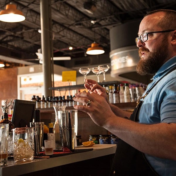 Popular Charlotte mixologist Bob Peters guides his Mixology 101 class at Earl’s Grocery in the art of concocting the perfect cocktail. (Photo by Justin Driscoll )