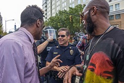 Capt. Mike Campagna engages with protesters outside of the Panthers game on Sunday, Sept. 25. - GRANT BALDWIN