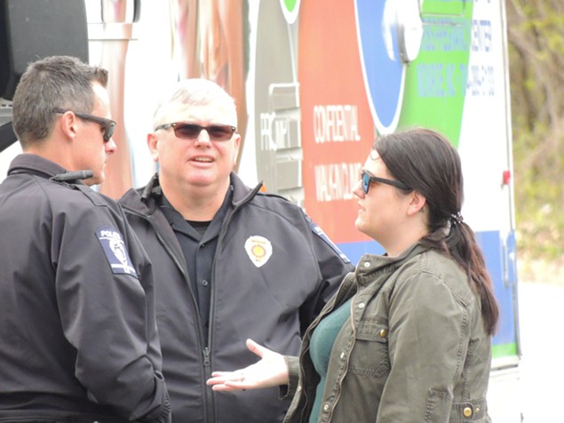 Calla Hales speaks with police about enforcing ordinances at a recent protest.