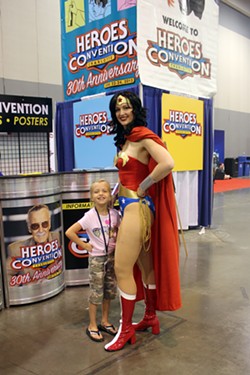 Wonder Woman poses with a young fan.