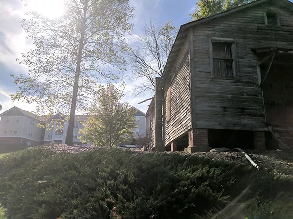 The Siloam School sits boarded up across a parking lot behind the Mallard Glen apartments in University City. (Photo by Ryan Pitkin)
