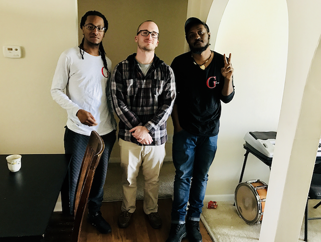Brown (right) with Gifted partners Walter Boston III (far left) and John Alex Harper at Boston's SouthPark apartment. (Photo by Mark Kemp)