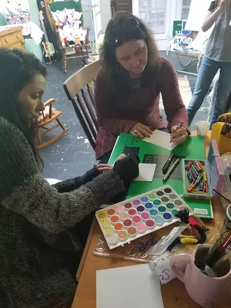 Lauren Kestner (left) collages with Hillary Belk, fellow co-founder of R Creative Collective (Photo courtesy of Lauren Kestner)