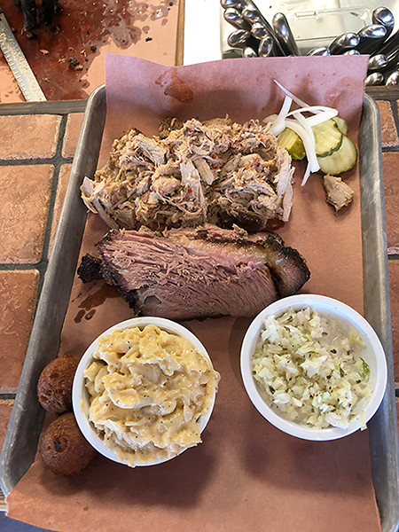 A platter of pulled pork, brisket, mac and cheese and coleslaw from Sauceman's. (Photo by Sophie Whisnant)