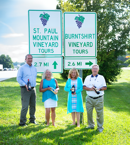 (L-R) Alan Ward and Barbara Ward of Saint Paul Mountain Vineyards and Sandra Oates and Lemuel Oates of Burntshirt Vineyards stand under their respective signs