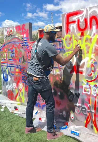 Crenshaw paints on trash.