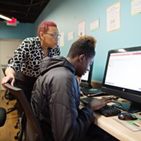 Resource coordinator Genine Donovan helps a client in the On Ramp upstairs resource center. (Photo by The Beautiful Mess)