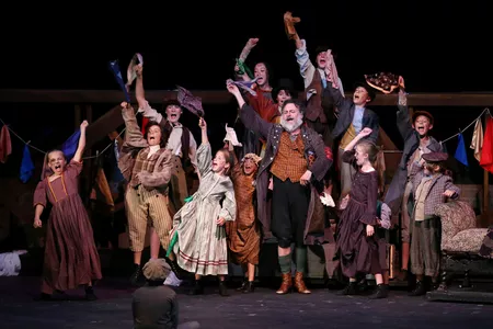 Rob Addison as Fagin with his band of juvenile thieves. (Photo by Chris Record)