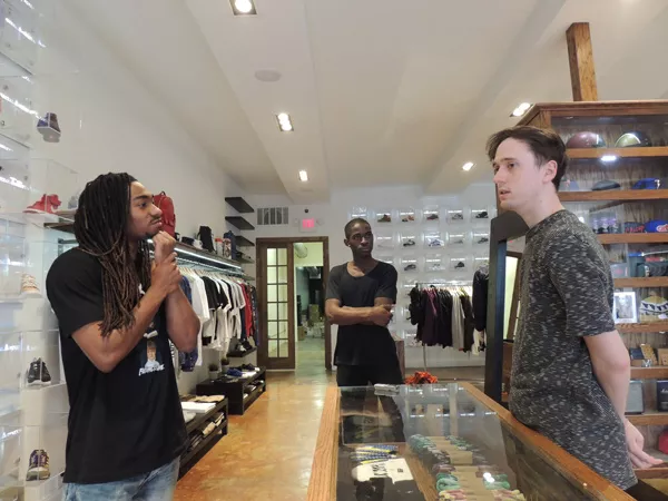 (From left) Vadoll Byers, Jeffrey Sekyere and Alex Brown discuss sneaker culture in Social Status, a boutique in Plaza Midwood. (Photo by Ryan Pitkin)