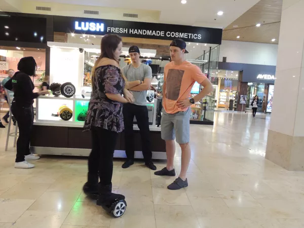Checkers Center Brody Sutter (left) and Woods are distracted by a hooverboard salesperson while shopping in SouthPark Mall on a recent Friday. (Photo by Ryan Pitkin)