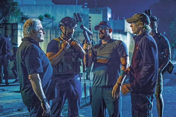 John “Tig” Tiegen (center) consults with cast and crew during the filming of 13 Hours. (Photo courtesy of Paramount Pictures)