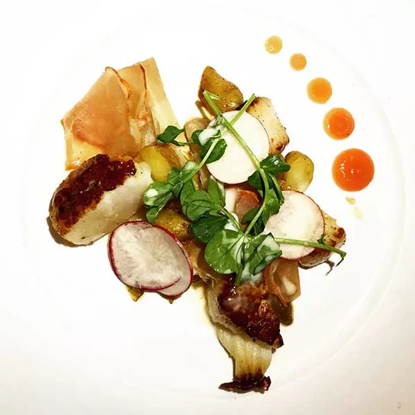 Scallop with caramelized Belgian endive, blood orange, serrano ham and black truffle potatoes from Lumiere. - CHRISSIE NELSON
