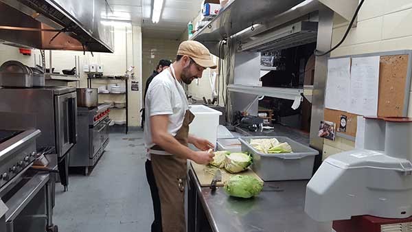 Chef Clark Barlowe processes shark-head cabbage in preparation for a midwinter farm dinner at Heirloom.