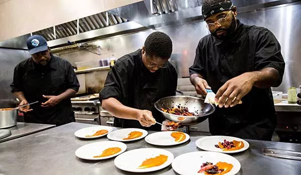 Mike Bowling (from left), Sam Dotse and Greg Williams prepare delicious sweet potato-watermelon molasses puree and vegetable hash. - PHOTO BY PETER TAYLOR