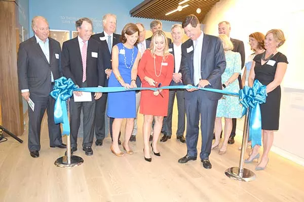 Betsy and Bill Blue (both holding ribbon) at the grand opening of Hopeway Foundation, a step-down facility for those discharged from acute mental health treatment. Alyson R. Kuroski-Mazzei (cutting the ribbon) is HopeWay’s clinical director. - LOUISE BONNER