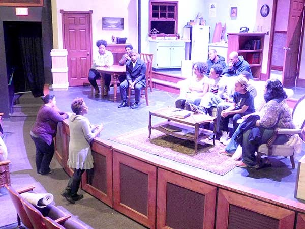 Kim Parati, lower left, addresses cast of A Raisin in the Sun after rehearsal. - BEN SPARENBERG