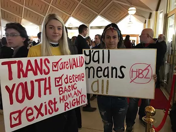 Hunter Schafer (left) and Miquel Rodrigues of Raleigh protest the North Carolina General Assembly during a special session on Wednesday, Dec. 21, 2016. (Photo by James Willamor)