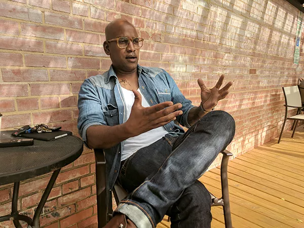 Alvin C. Jacobs, Jr., discusses his role as an activist and documentarian outside of Smell Cat Coffeehouse. (Photo by Ryan Pitkin)