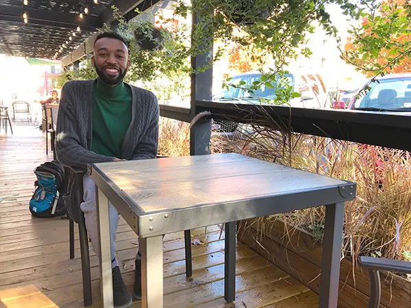 Jordan lounges outside the Smelly Cat in NoDa (Photo by Mark Kemp)