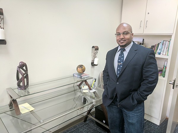 Kareem Puranda in his Charlotte office, where he meets in groups and one-on-one with police officers to deal with potential psychological issues. (Photo by Ryan Pitkin)