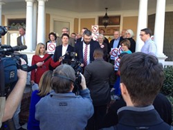 PHOTO COURTESY OF SHARON HUDSON - Sharon Hudson (far left, holding sign) stands with other members of Widen I77 to announce a lawsuit against the state in January 2015.