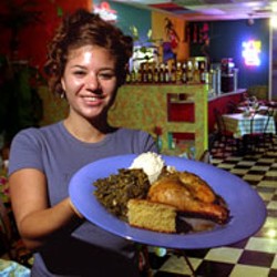 RADOK - Waitress April Beasley dishes up the chicken at - Anntony's Caribbean Caf