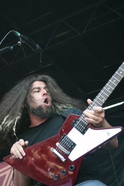 WARPED MINDS: Coheed and Cambria's Claudio Sanchez gets the crowd, and his hair, going during the Vans Warped Tour at Verizon Wireless Amphitheatre on July 23. - JEFF HAHNE