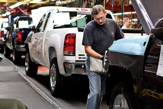 Worker helps assemble trucks at GM's Fort Wayne, Ind. plant (photo pickuptrucks.com)