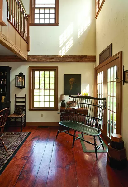 12-over-12 windows, hand-stained wide-plank flooring, and 18th-century barn beams are featured throughout the home. - DEBORAH DEGRAFFENREID