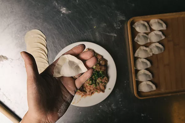 A freshly pressed dumpling before it’s sent to the steamer. - THOMAS SMITH