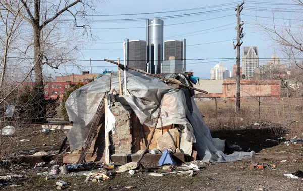A makeshift homeless persons structure is seen, with General Motors headquarters headquarters in the background, in Detroit, March 31, 2009.