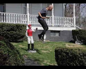 A still from Lawn Jockey Leap Frog, from Tim Davis’s Upstate New York Olympics at the Samuel Dorsky Museum.