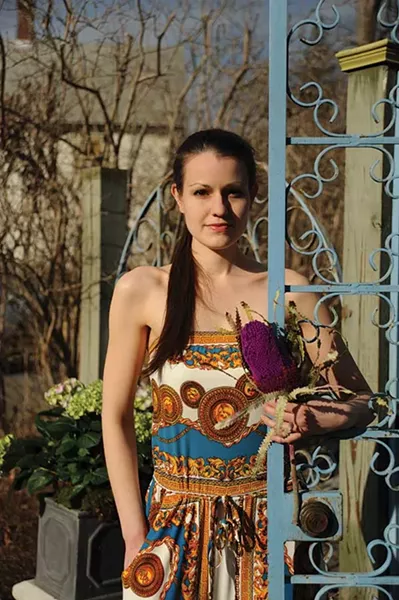 Abra Duprea wearing a Versace-print inspired one-piece jumpsuit from Cesare + Lili in Rhinebeck. Bracelets and necklace by David Urso of Green Cottage.