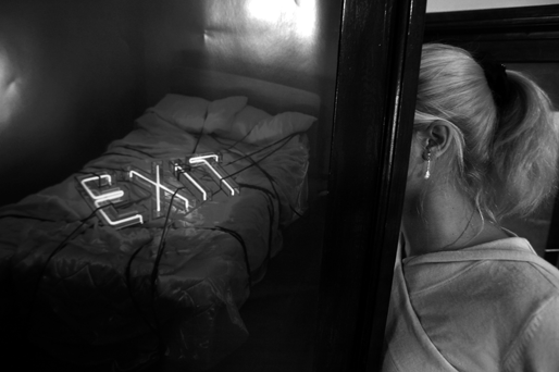 Anca, a former Romanian sex slave, hides her face behind a poster in Bucharest.