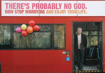 Author Richard Dawkins, who wrote "The God Delusion," stands on a bus in London at the launch of an atheist advertising campaign on January 6, 2009. Photo by Reuters/Andrew Winning.